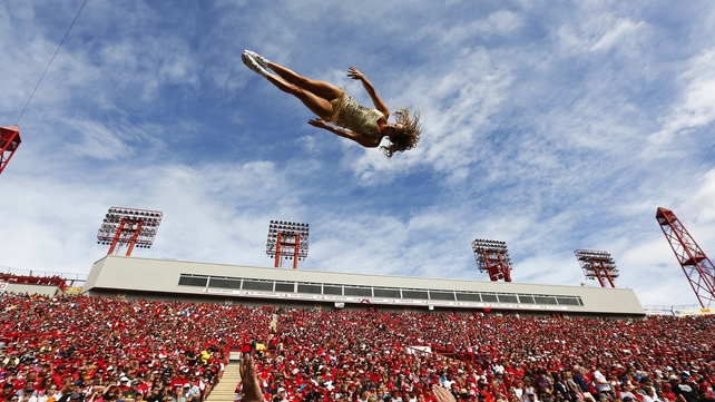 A cheerleader for the Edmonton Eskimos goes flying through the air  at McMahon Stadium in Alberta, Canada