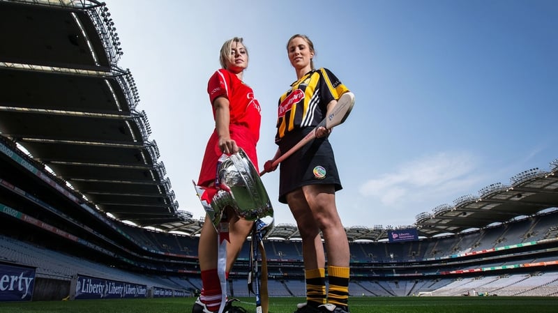 Cork captain Anna Geary and her Kilkenny counterpart Leann Fennelly with the senior camogie trophy at Croke Park