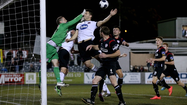 Derry City goalkeeper Ciaran Gallagher clears the ball under pressure from a Dundalk attacker during their Premier Division clash at Oriel Park