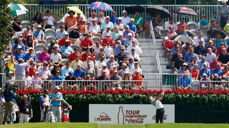 A packed gallery watch Rory McIlroy hits his tee shot on the 18th