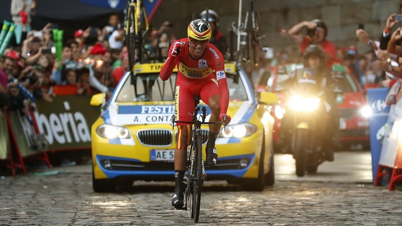 A smiling Alberto Contador crosses the finish line of the final stage of the Vuelta a Espana