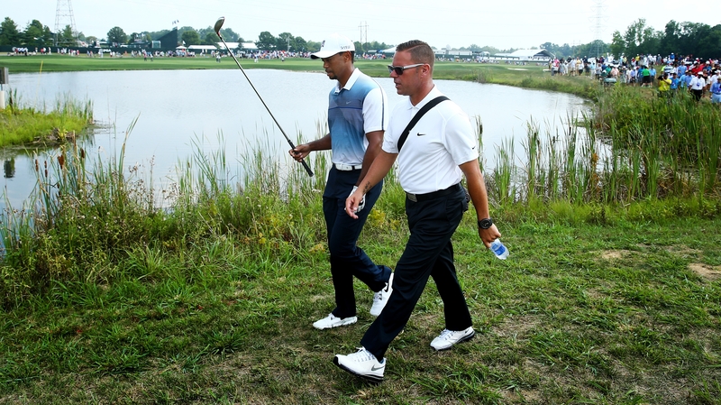 Tiger Woods (l) recently split with swing coach Sean Foley
