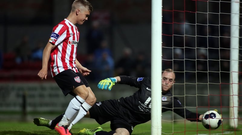 Drogheda goalkeeper Michael Schlingerman tries to prevent Rory Patterson's deflected free kick crossing the line
