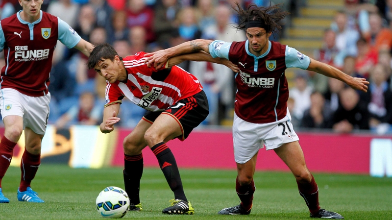 Burnley's George Boyd (right) tussles for possesion with Sunderland's Santiago Vergini