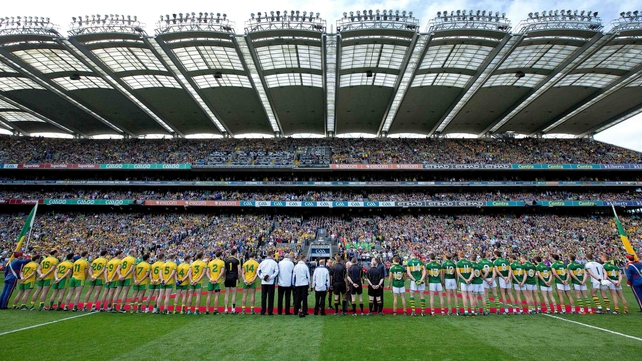 Donegal and Kerry teams line with the match officials for the senior final