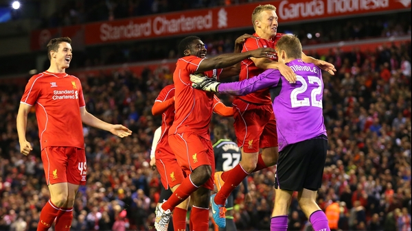 Liverpool players celebrate after Albert Adomah's miss