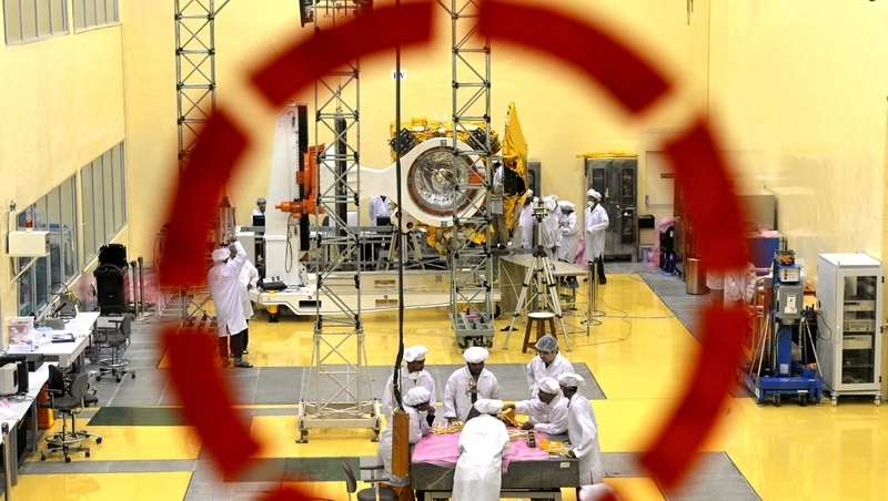 Scientists and engineers work on a Mars Orbiter vehicle at the Indian Space Research Organisation's satellite centre in Bangalore