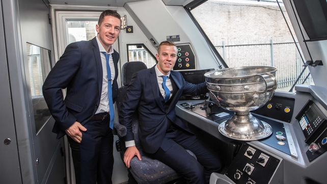 Kerry's joint captains Kieran O'Leary and Fionn Fitzgerald board the train to Tralee with the Sam Maguire on Monday