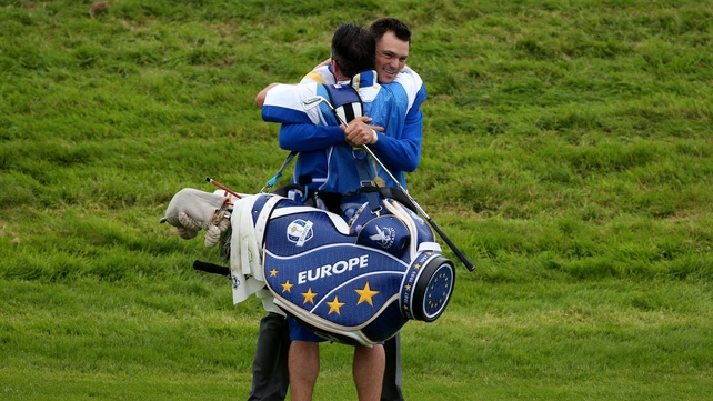 Europe's Martin Kaymer celebrates winning his singles match with caddie Craig Connelly