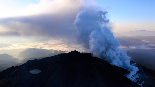 More than 30 hikers were found in "cardiac arrest" near the peak of an erupting volcano in Japan