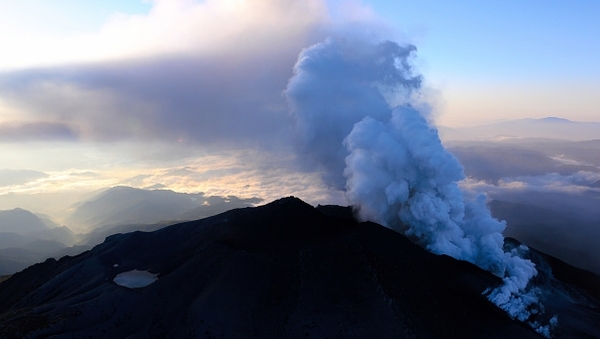 More than 30 hikers were found in "cardiac arrest" near the peak of an erupting volcano in Japan