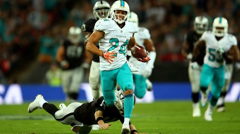 Cortland Finnegan of the Miami Dolphins returns a fumble to score a touchdown