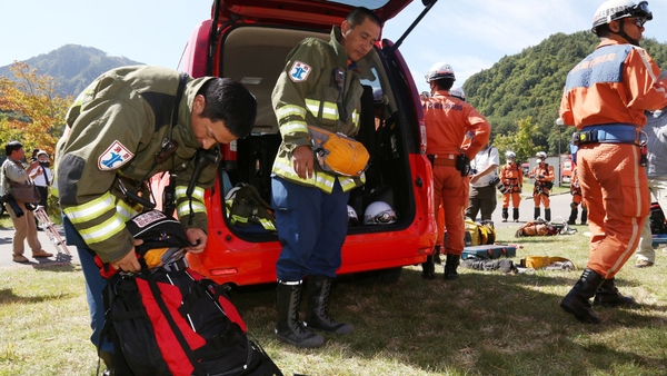 Rescue workers put their gear away as rescue operations on Mount Ontake are halted for the day