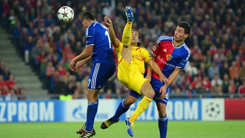Ivan Ivanov and Marek Suchý of FC Basel battle with Lazar Markovic of Liverpool