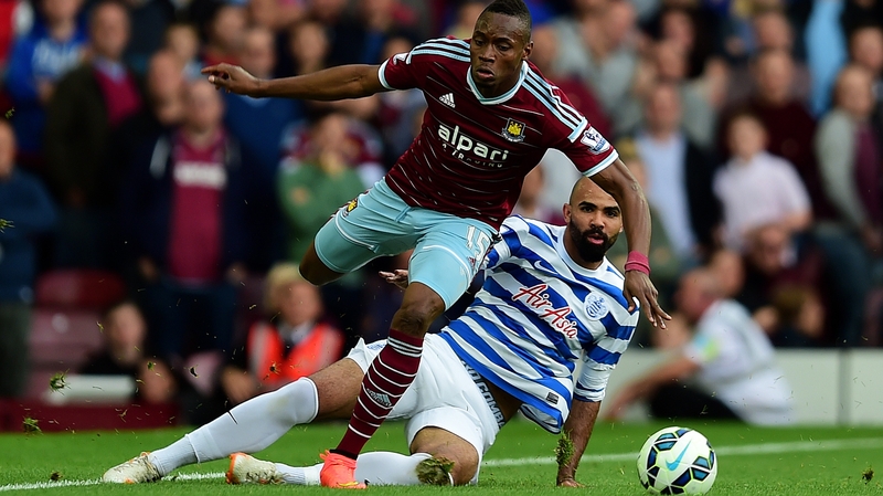 Goalscorer Diafra Sakho of West Ham battles for the ball with QPR's Sandro