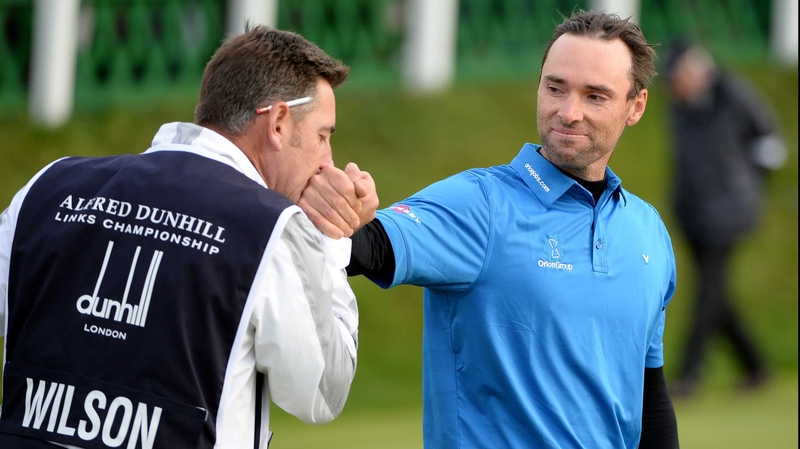 Oliver Wilson gets a kiss from his caddie after ending his European drought