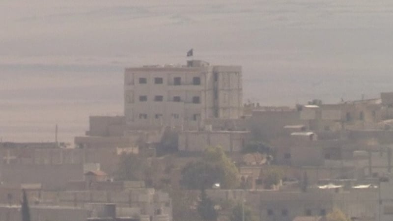 The flag of the Islamic State group flies on a building in eastern Kobane