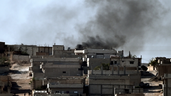 Black smoke is seen rising over the border town of Kobane