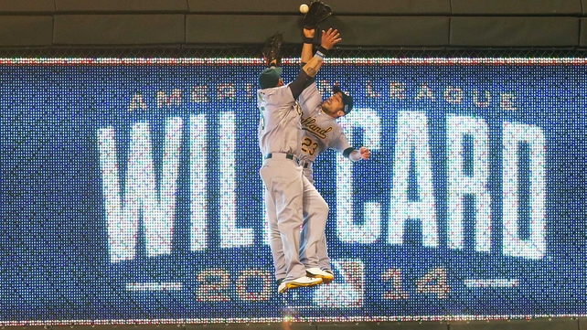 Jonny Gomes and Sam Fuld of the Oakland Athletics collide in the 12th inning during the American League Wild Card game at Kauffman Stadium in Kansas City