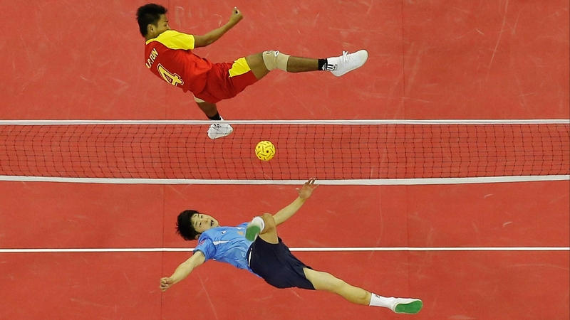 Aung Pyae Tun of Myanmar (top) and Kim Youngman of South Korea compete for the ball in the sepak takraw regu semi-finals at the Asian Games in Incheon in South Korea