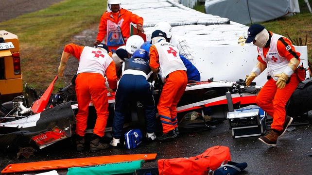 Medics attend Jules Bianchi of Marussia after crashing during the Japanese Grand Prix at Suzuka