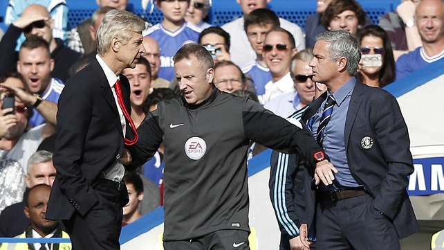 If looks could kill - Arsenal boss Arsene Wenger and Jose Mourinho of Chelsea are kept apart by fourth official Jonathan Moss
