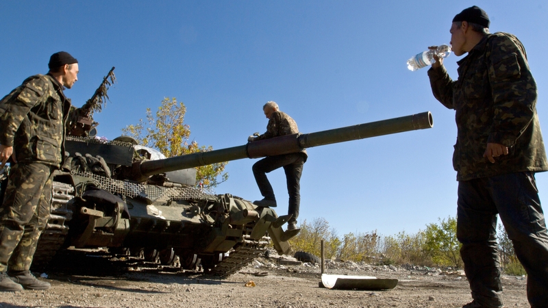 Ukrainian servicemen repair their equipment in a base camp near the town of Debaltseve in Donetsk