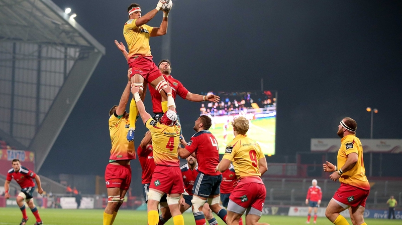 Munster's Billy Holland with Aaron Shingler of Scarlets
