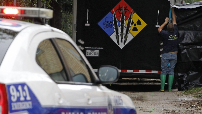 Specialist cleaning crews seal off the apartment where the health care worker lives