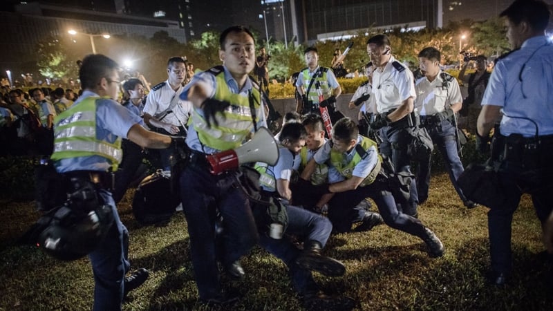 Large numbers of police forced the crowds back, spraying pepper spray at those who resisted