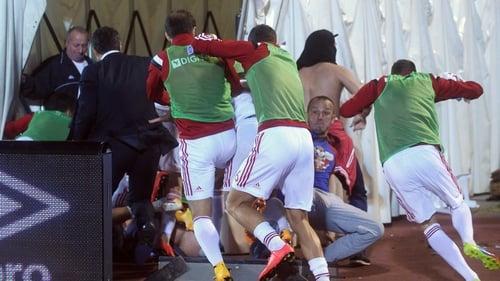 Albanian players run for cover