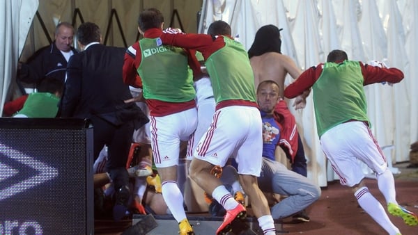 Albanian players run for cover
