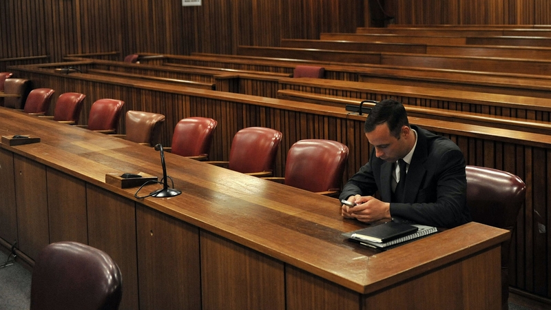 Oscar Pistorius sits on his own before proceedings on day three of sentencing procedures at a South African court