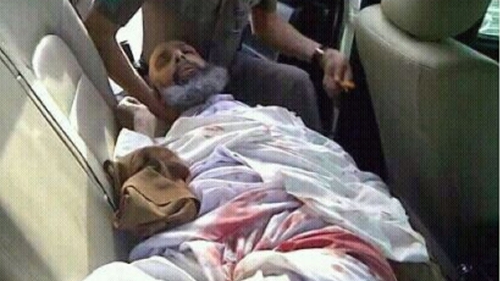 Shia cleric and government critic Sheikh Nimr al-Nimr lies wounded in the back of a police car, following his arrest