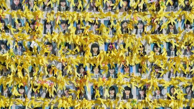 Portraits of the victims of the sunken South Korean ferry 'Sewol' are seen with yellow ribbons at Gwanghwamun square in Seoul, South Korea