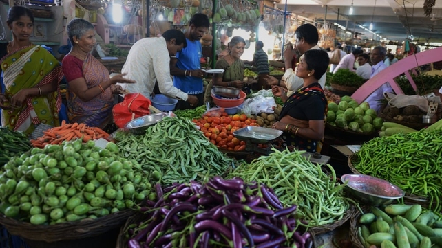 Indian shoppers buy vegetables at the Raithu Bajar, or farmers market, on World Food Day in Hyderabad