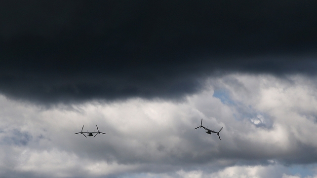US Marine MV-22 Osprey tiltrotor aircraft fly near the construction site of a new Ebola treatment