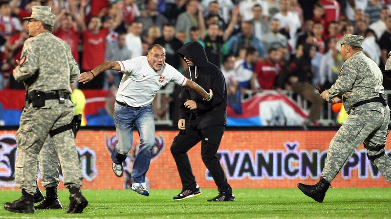Serbian supporters invade the pitch