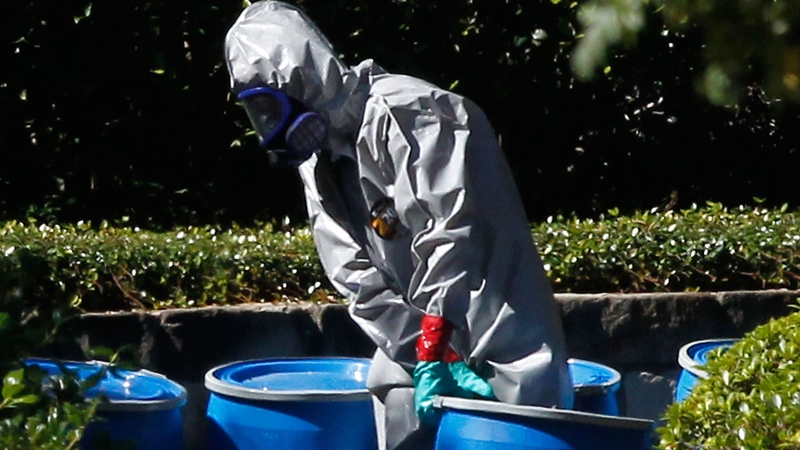 A hazmat worker removes a barrel from the apartment where US nurse Amber Vinson lives