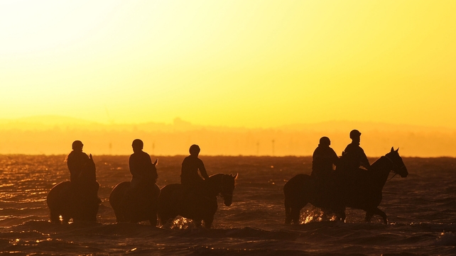 Riders on horseback at Altona Beach in Melbourne