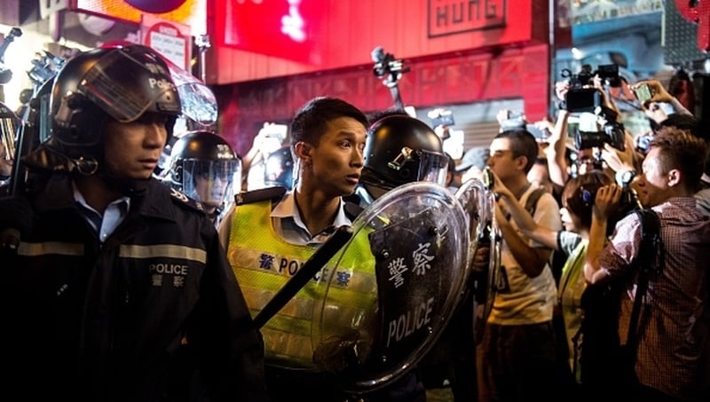Police push through members of the Occupy movement during a clash in the Mongkok district of Hong Kong