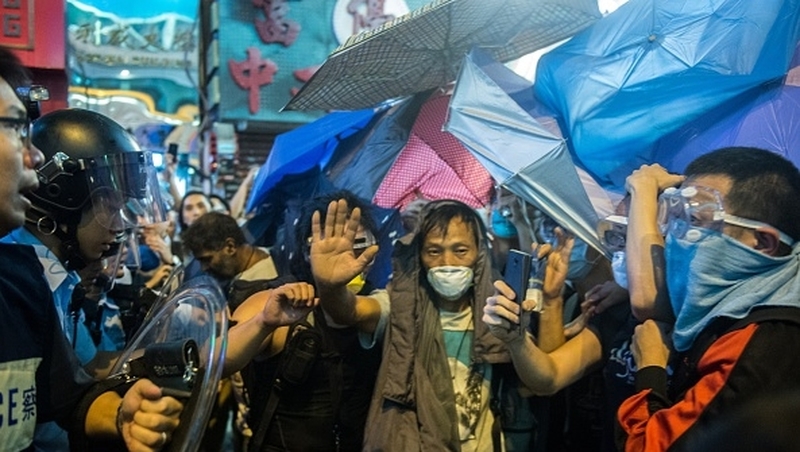 Protesters some wearing protective goggles and helmets, helped to build fresh barricades