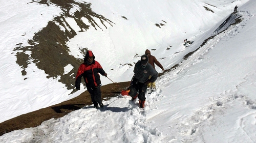Members of the Nepalese army recover the body of a trekker from the Thorung La mountain pass
