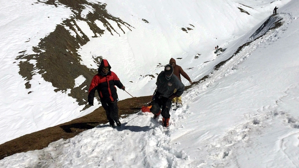 Members of the Nepalese army recover the body of a trekker from the Thorung La mountain pass