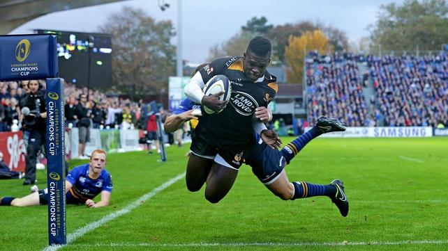 Christian Wade scores a try despite the efforts of Zane Kirchner during the Leinster vs Wasps Champions Cup game