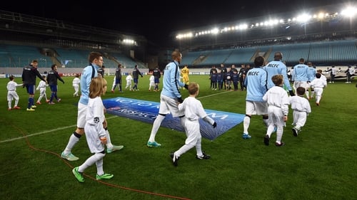 City's players walk out onto the field before an empty stadium