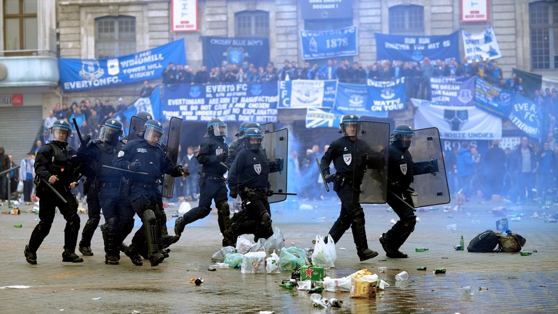 French riot police run on the Grand Place, the main square of Lille, where Everton's supporters have gathered