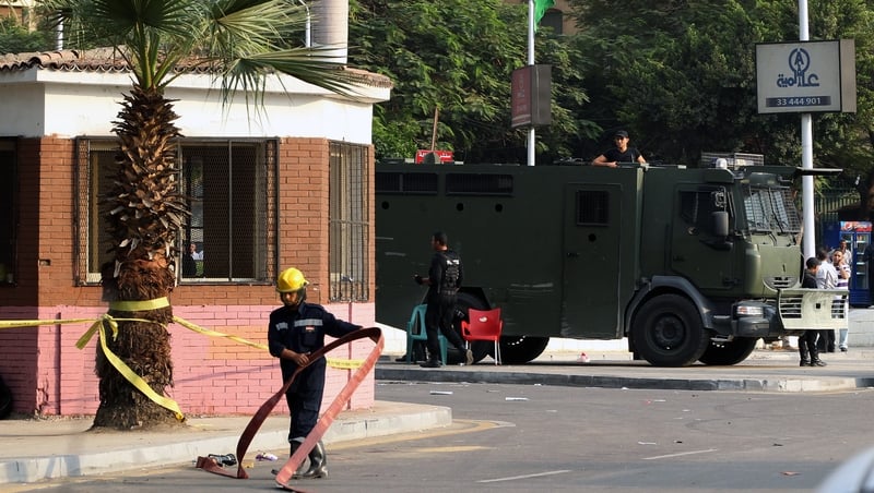 Egyptian fireman and soldiers at the scene of explosion outside Cairo University on Wednesday