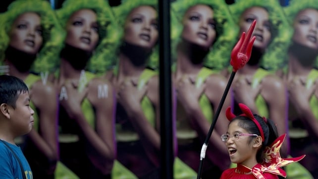 A girl wears a devil costume as she attends the Cats and Dogs Halloween costume competition in Manila