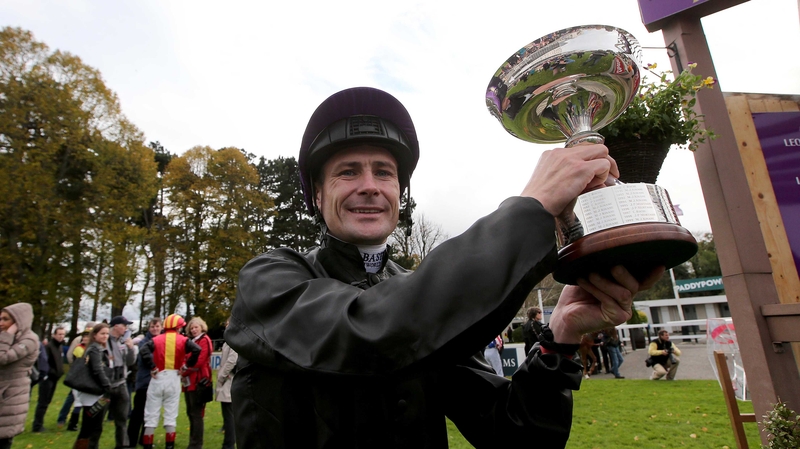 Champion jockey Pat Smullen shows off the trophy